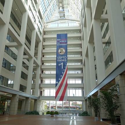 https://upload.wikimedia.org/wikipedia/commons/e/e7/BEST_PLACES_TO_WORK_IN_THE_FEDERAL_GOVERNMENT%2C_USPTO_RANKS_1_%28Banner%29_-_USPTO_building_in_Alexandria%2C_Virginia%2C_2014-09-24.jpg